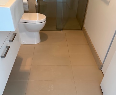 Spotless tiled bathroom floor and toilet area ready for a tenancy check-out inspection